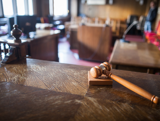 Image of an empty courtroom from the view of the judge's seat