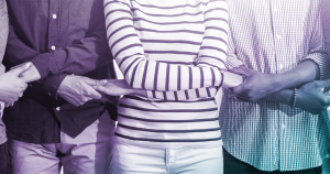 Line of people with their arms crossed joining hands